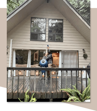 photo of a couple standing on the deck of their new house